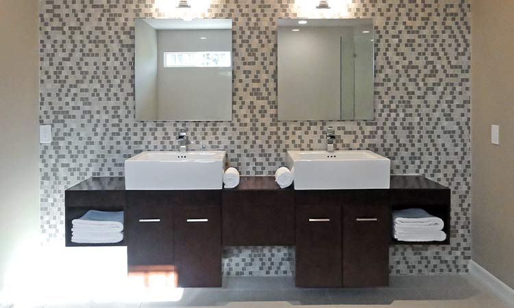 Custom bathroom vanity of wood, vessel sinks and tiled floor